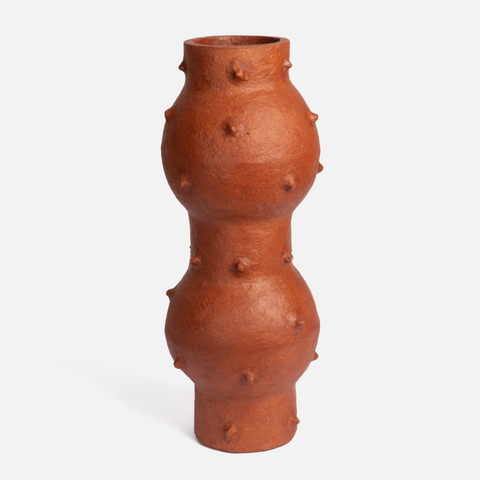 Terracotta vase with bumpy texture on a white background