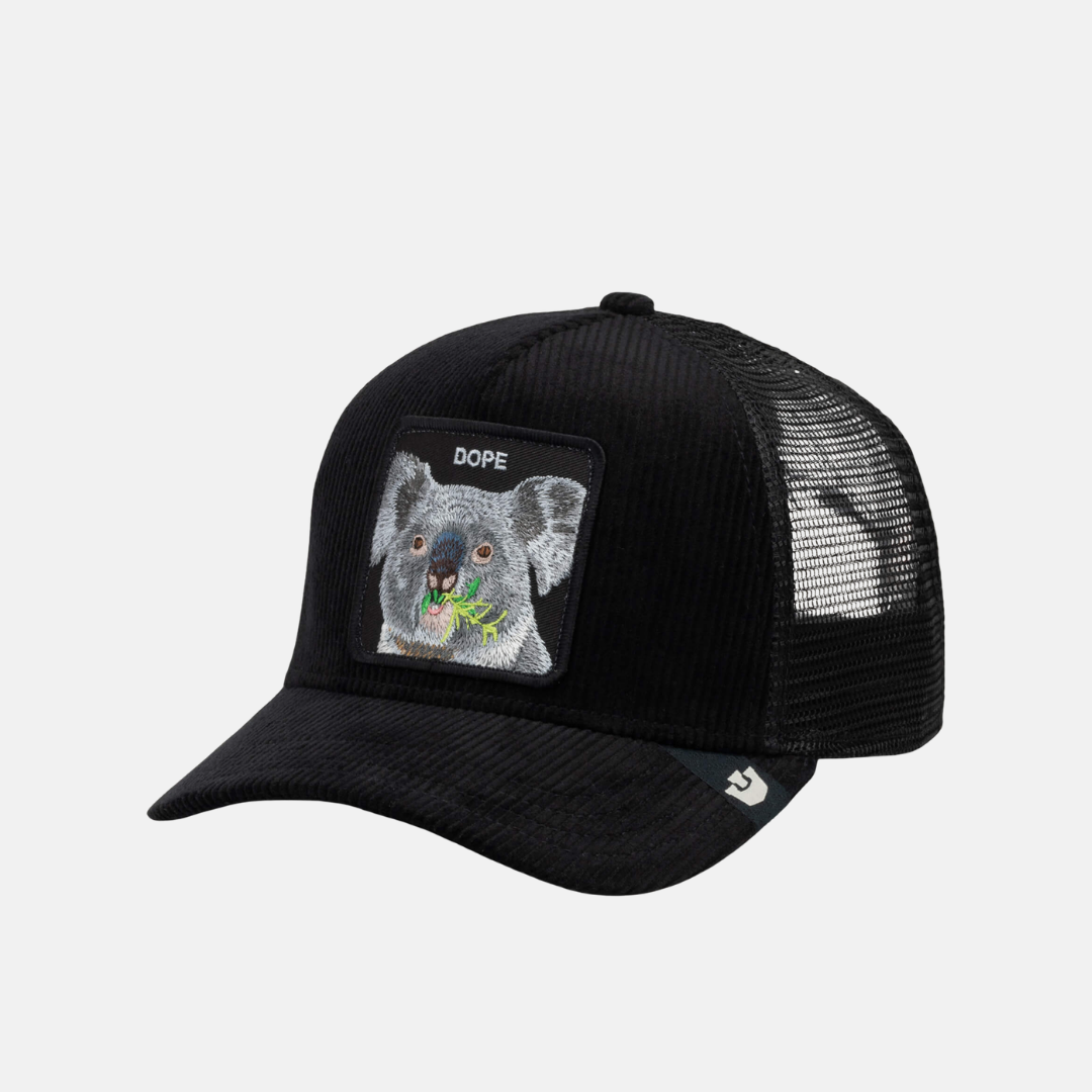 A black trucker hat with a front patch featuring a koala illustration and the word 'DOPE' on a light gray background.
