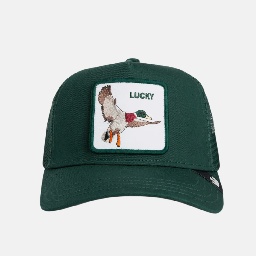 A dark green trucker hat with a white rectangular patch on the front featuring an embroidered flying duck and the word 'LUCKY'.