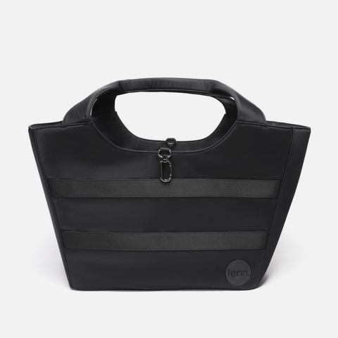 A black tote bag with a structured rectangular shape, featuring a top handle, horizontal black stripes, a silver zipper closure, and a circular 'fenn.' logo patch on the bottom right, set against a plain light gray background.