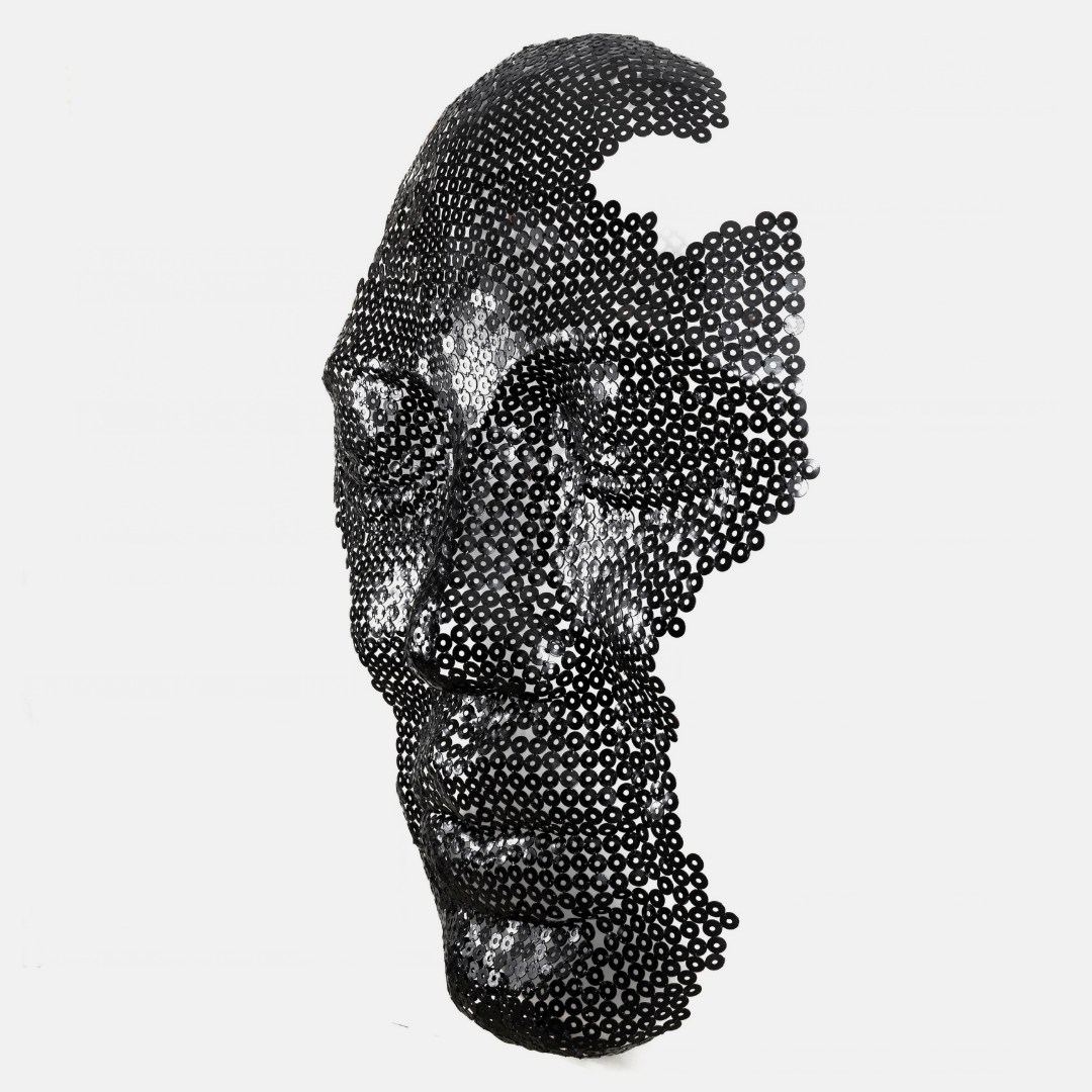 A black metal sculpture of a human face profile, constructed from a dense field of small circular black discs, set against a solid light gray background.