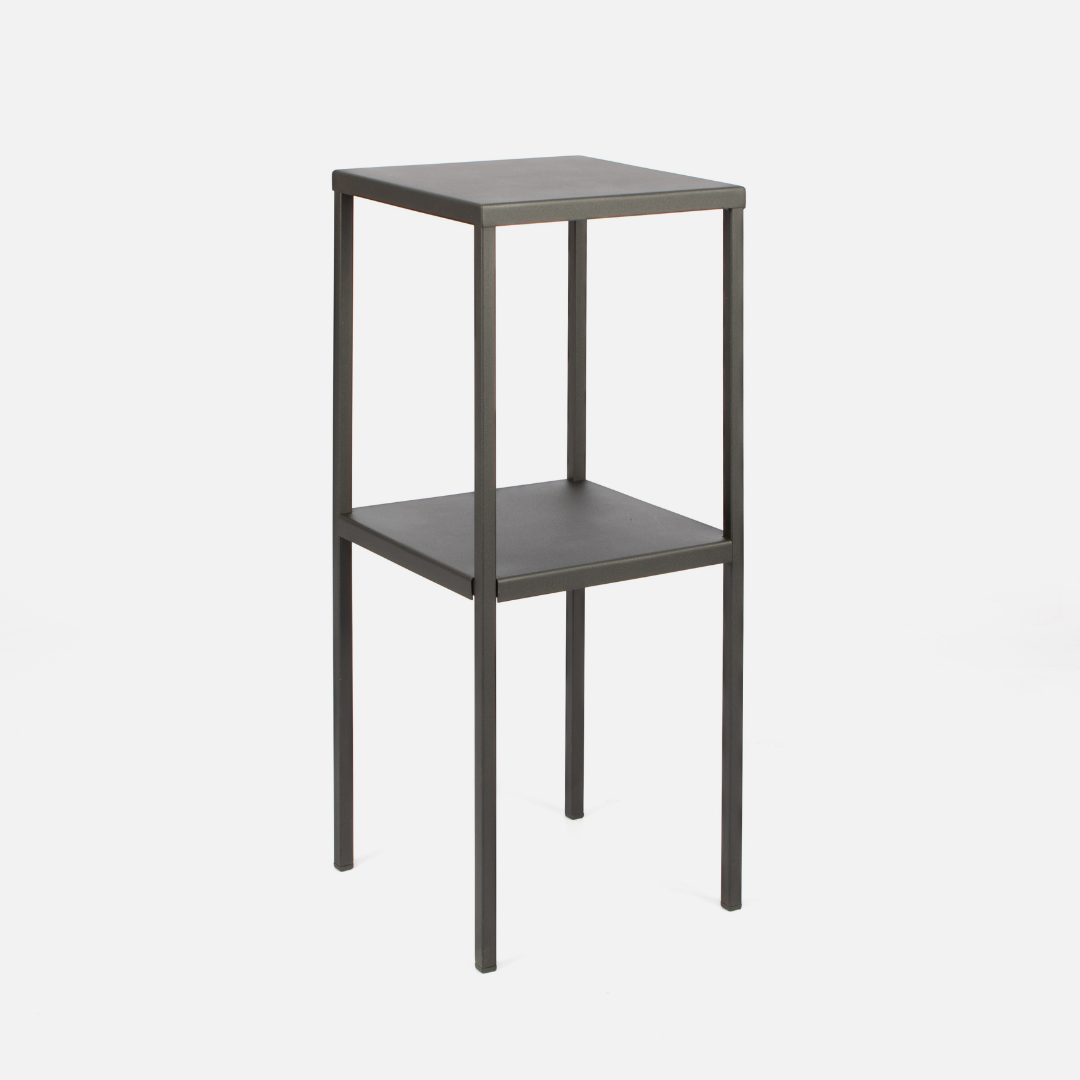 A tall, black, powder-coated steel side table with a rectangular shape and one shelf.
