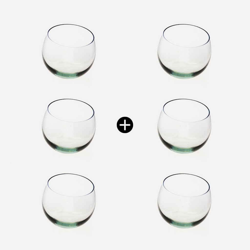 Six clear glass tumblers arranged in two rows on a white background