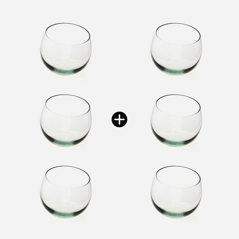Six clear glass tumblers arranged in two rows on a white background
