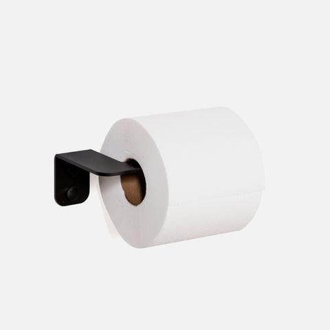 A matte black powder-coated toilet roll holder with a roll of toilet paper.